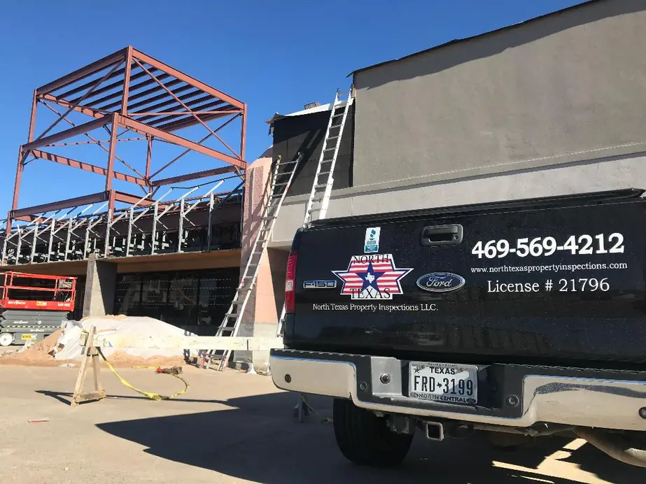 North Texas Property Inspections truck at a steel frame commercial building under construction