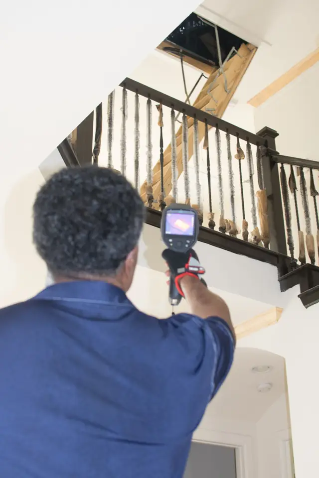 Handheld thermal imaging camera in use during a residential inspection